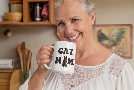 Cat Mom ceramic mug 15oz – bold black retro cat silhouette design, held by woman at home