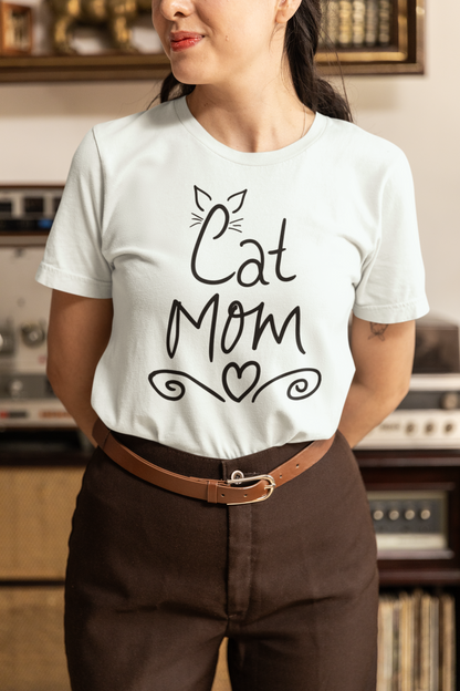 Woman wearing heather ice blue Cat Mom t-shirt with handwritten design and heart doodles
