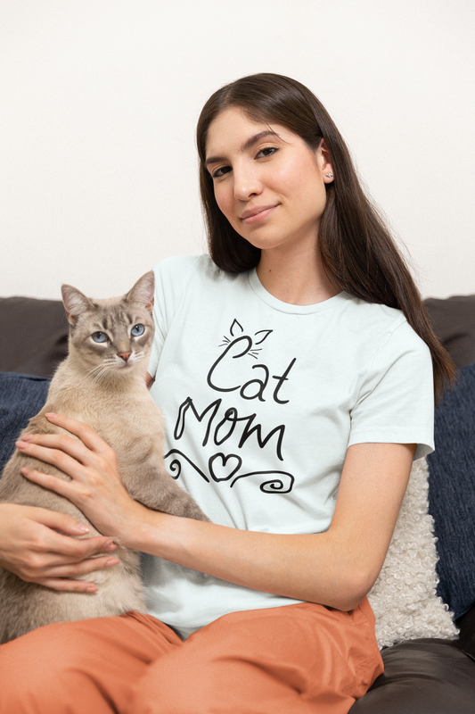 Woman wearing heather ice blue Cat Mom t-shirt with handwritten design and heart doodles

