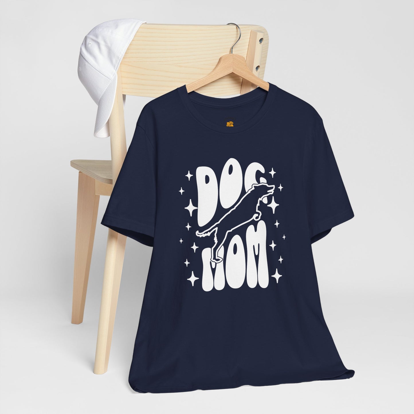Navy blue t-shirt with a graphic design saying "dog mom" and a jumping dog on a white background