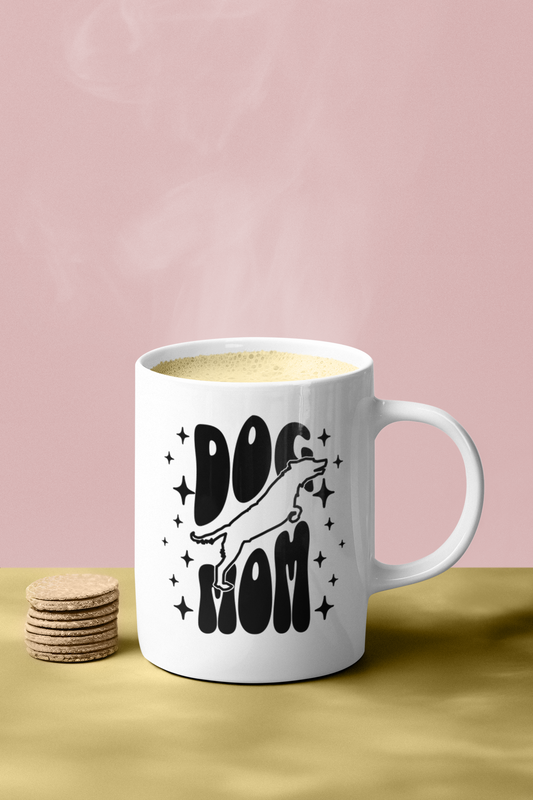 Dog Mom mug 11oz filled with coffee next to cookies — ceramic mug with star accents and black lettering